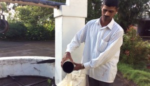 A farm worker measures rainfall in K. K. Naren’s coffee farm. (Photo by K. K. Naren) 