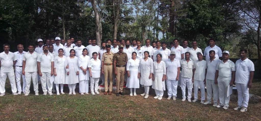 Police personnel with women at a rifle training camp in Kodagu’s Gonikoppal village. | Photo: By special arrangement